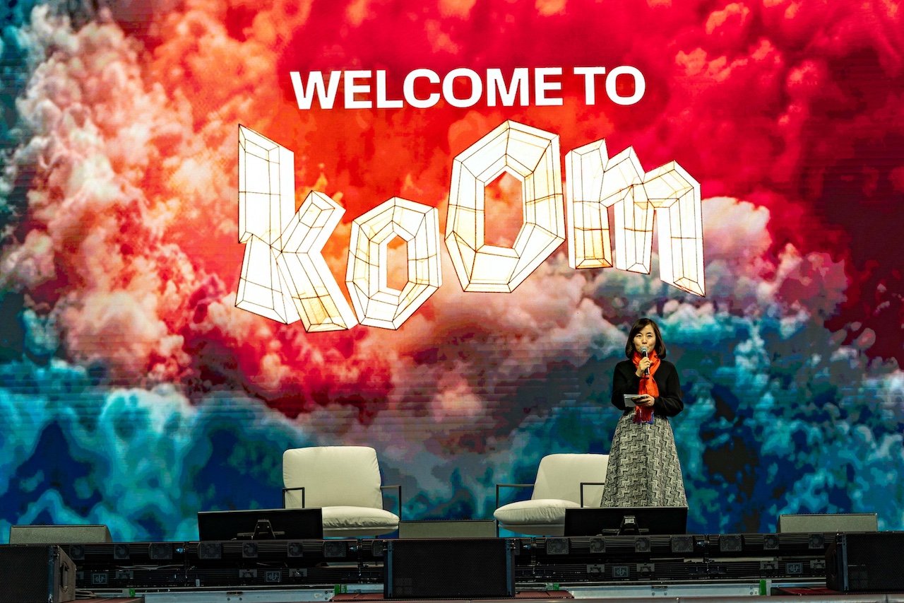 Welcome to KOOM — speaker on the main stage