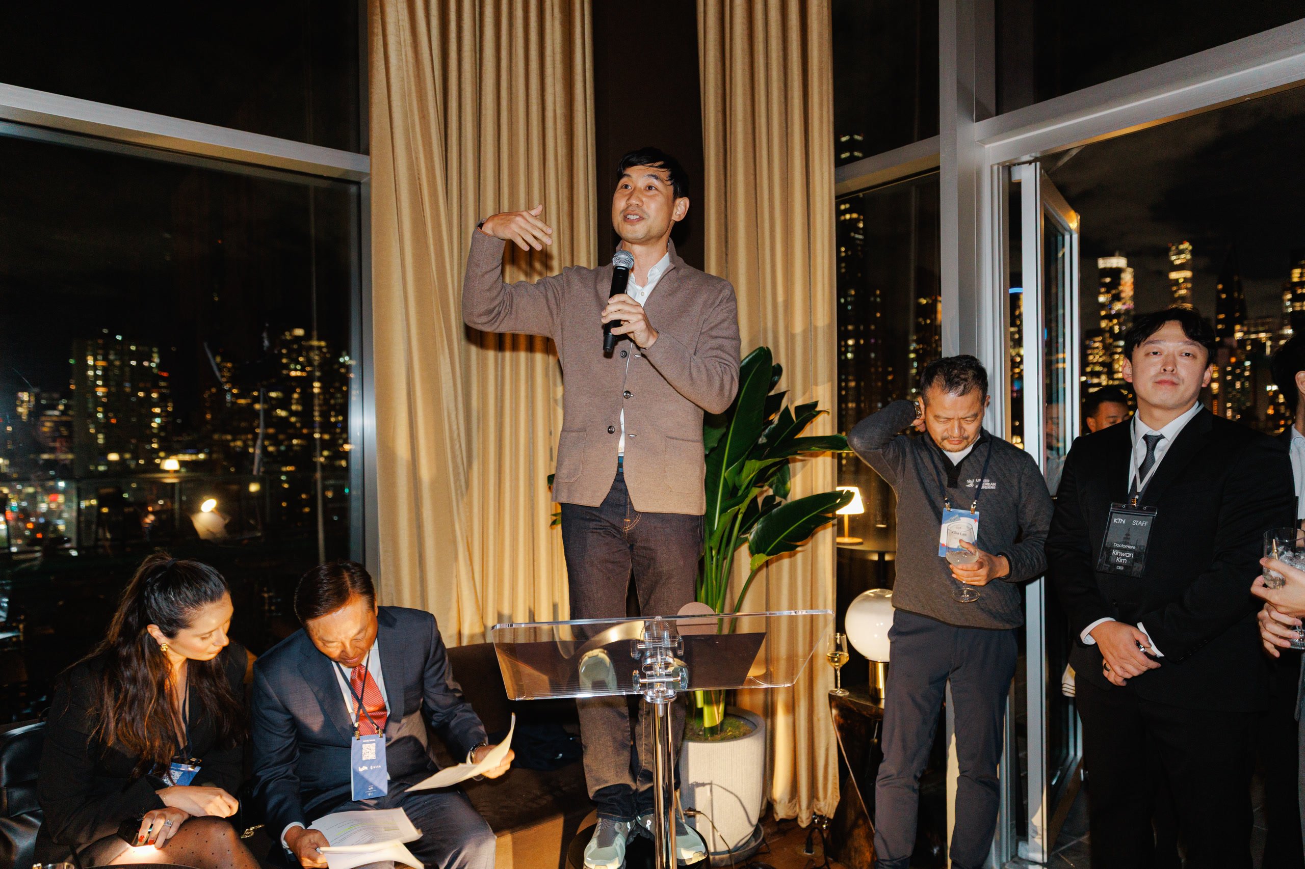 Guests mingling at a rooftop gathering at night