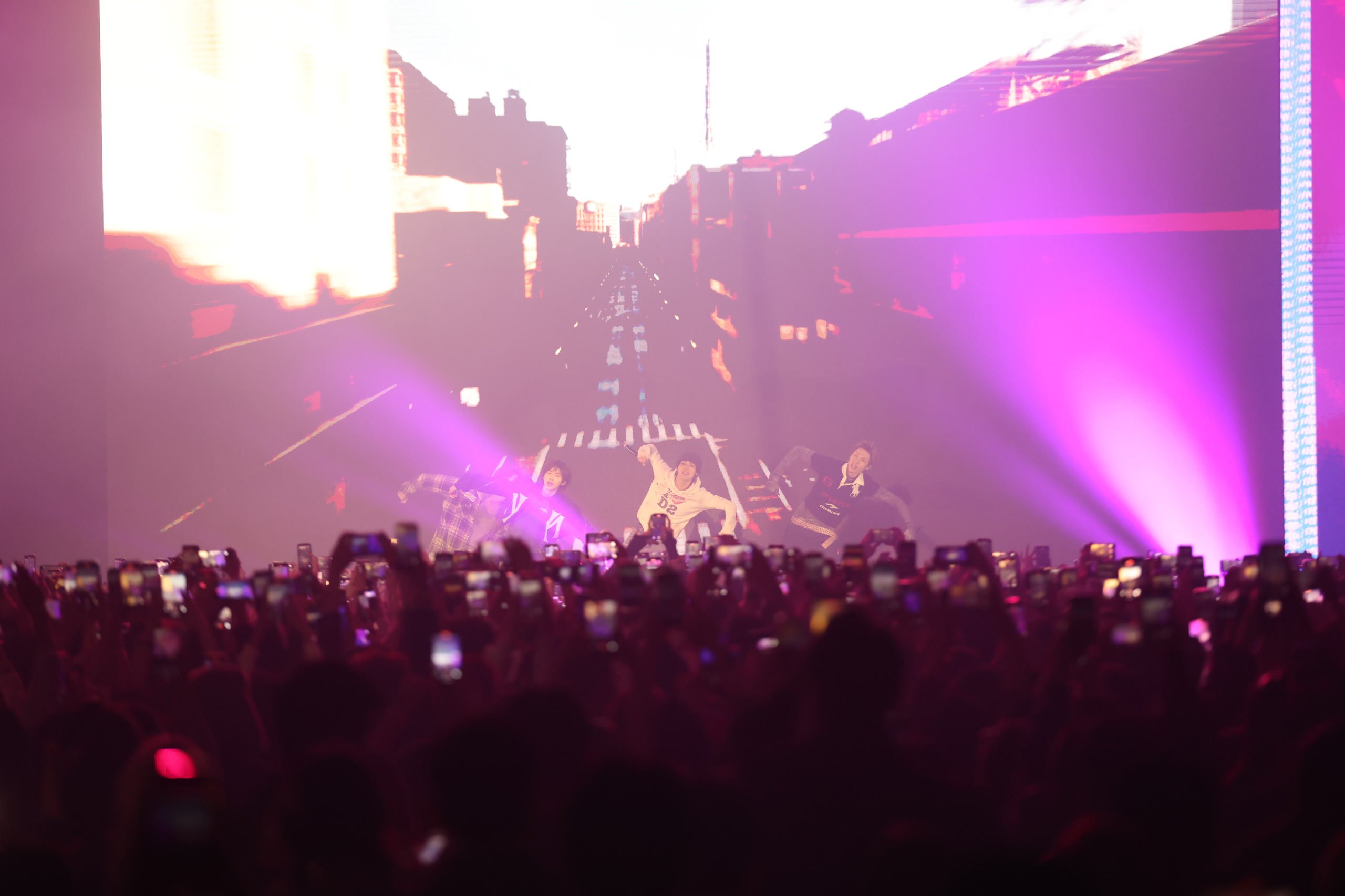 Concert performance lit in purple at KOOM