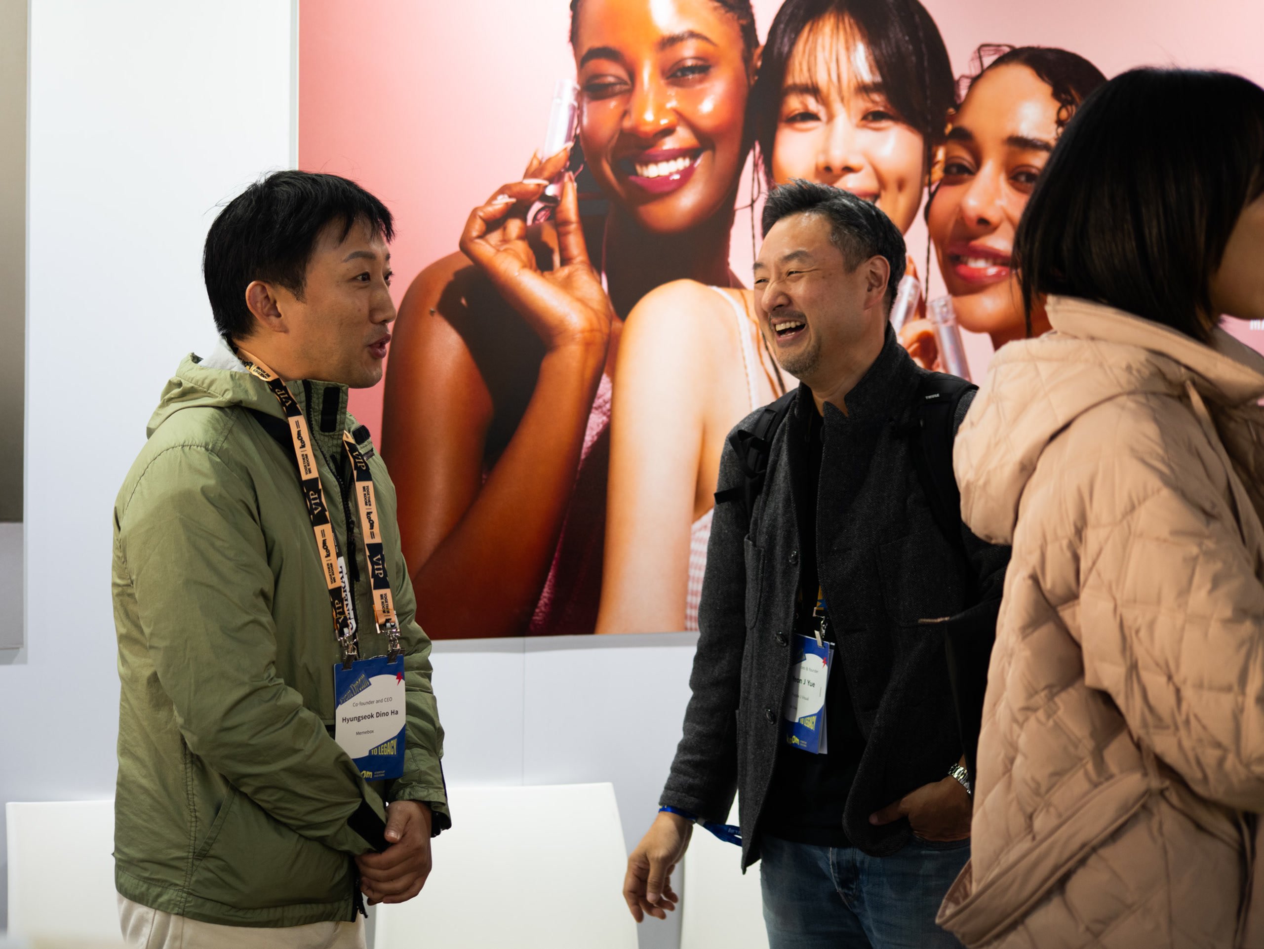 Attendees chatting at an exhibition booth